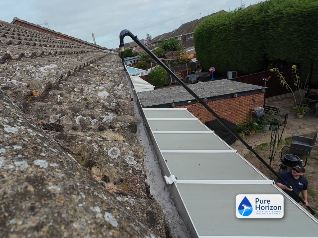 Pure Horizon using high-reach skyVac poles to clear guttering above a conservatory roof