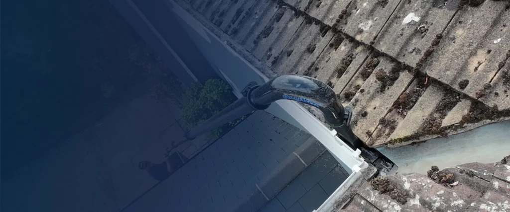 SkyVac gutter vacuum removing moss and debris from a residential gutter in Suffolk
